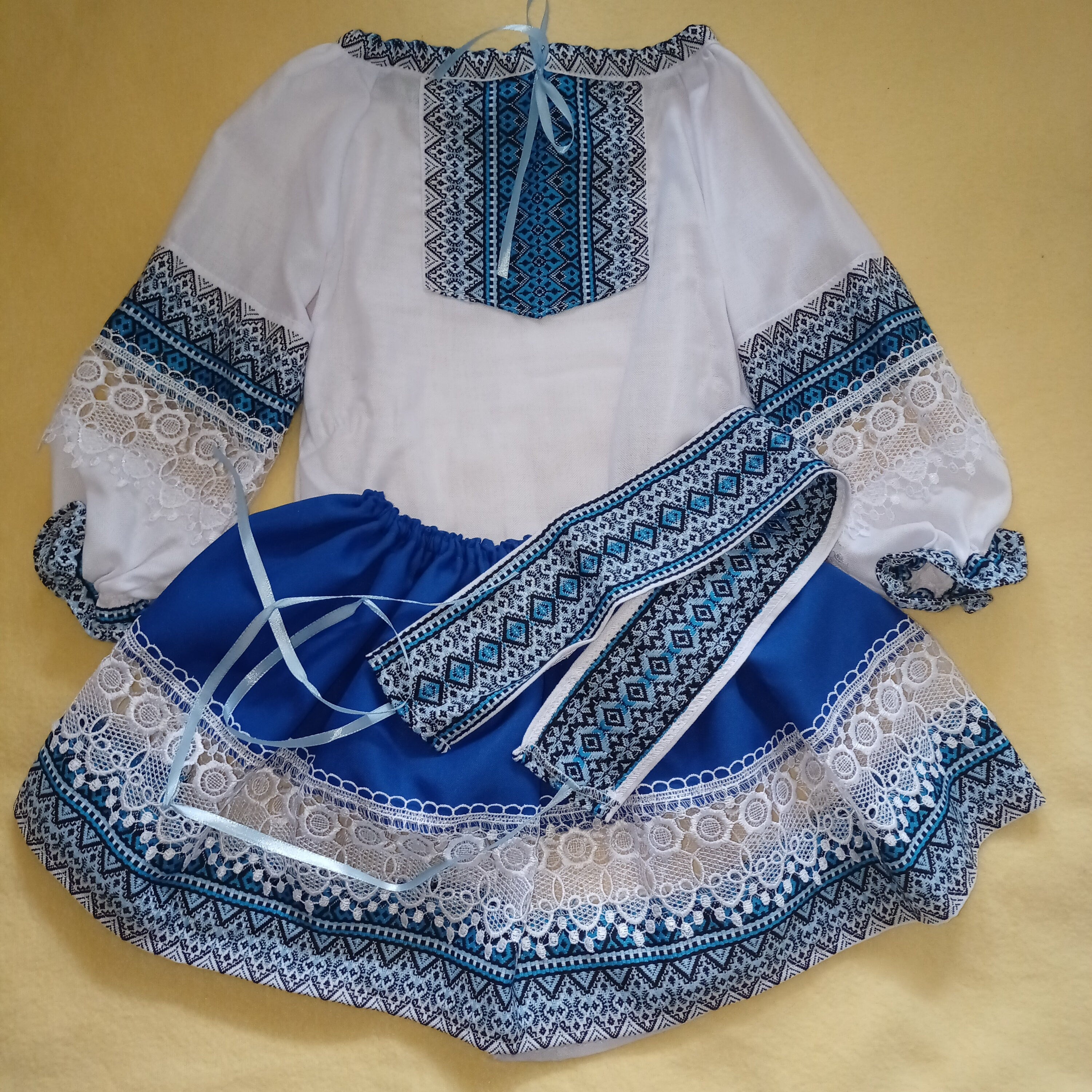 Ukrainian Hutsul folk costume for girls, blue woven set with lace, includes blouse, skirt, and belt, perfect for cultural events.