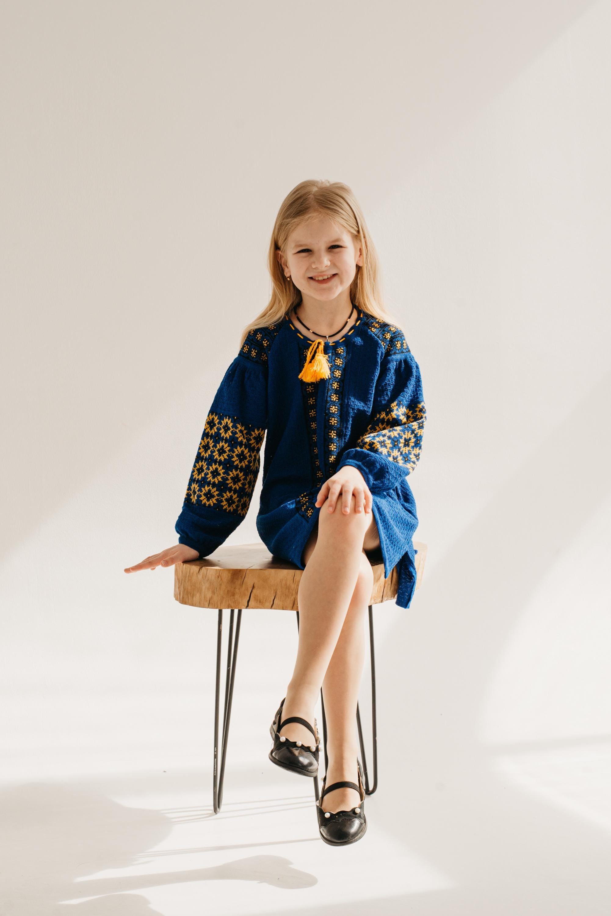 Girl wearing a Ukrainian knitted dress with traditional embroidery; perfect for special occasions or everyday wear.