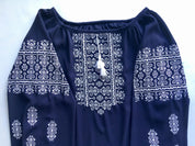 Marsala boho Vyshyvanka blouse with white geometric embroidery on dark fabric, showcasing Ukrainian peasant shirt style.