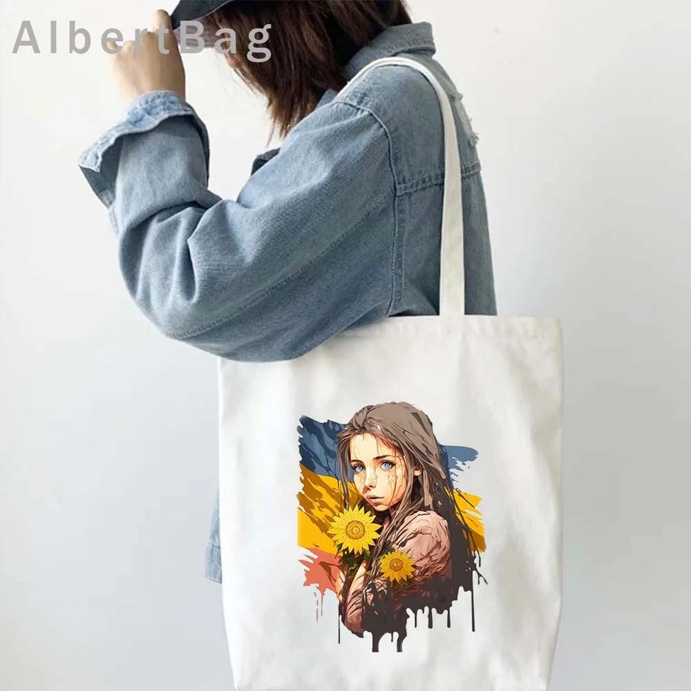 Woman holding Ukrainian patriotic grocery tote bag with sunflower design.