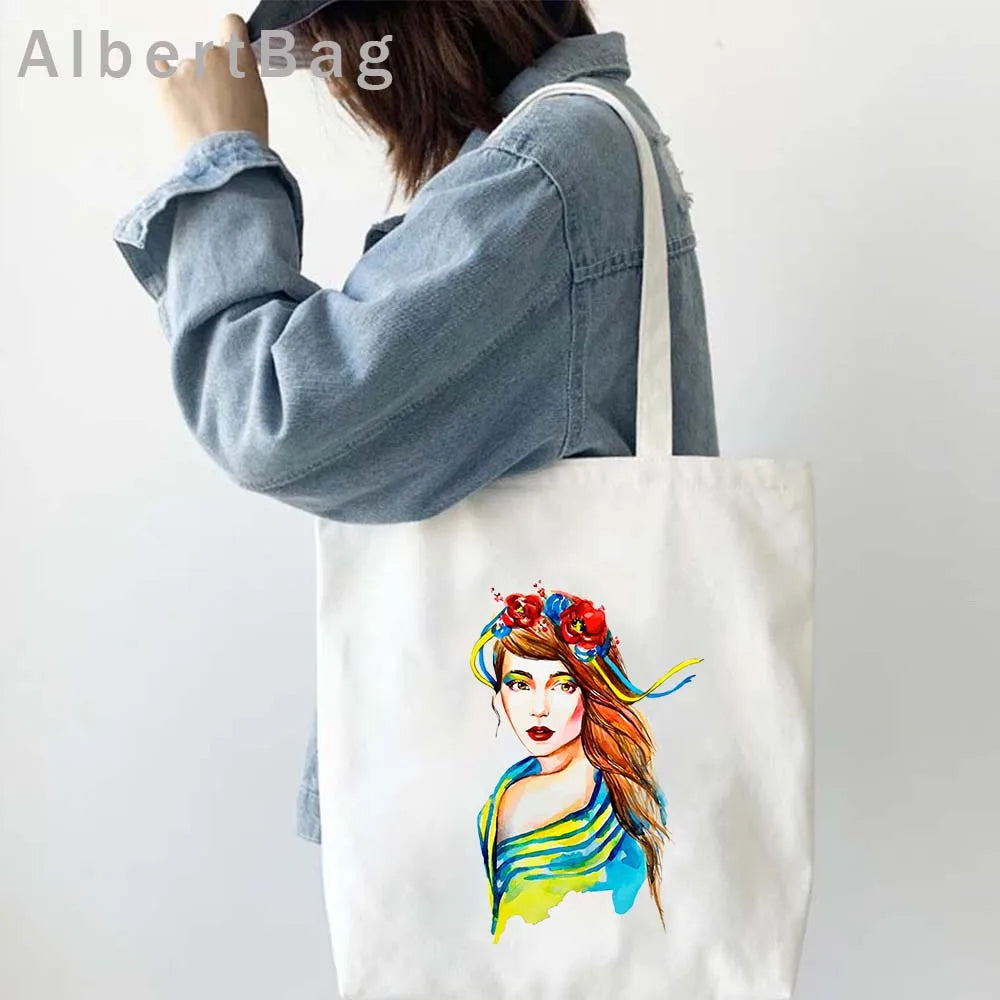 Woman carrying Ukrainian patriotic grocery tote bag with colorful print design.