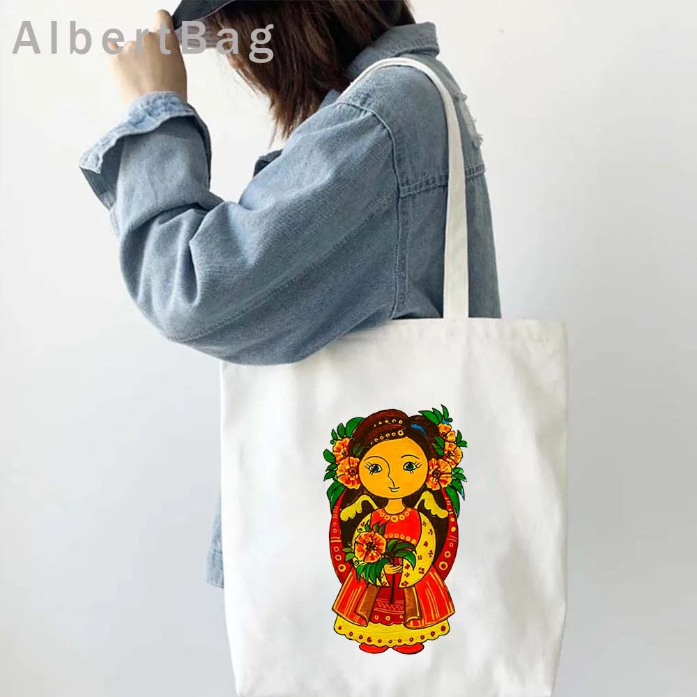 Woman carrying Ukrainian Patriotic Grocery Tote Bag with vibrant cultural design in colorful print