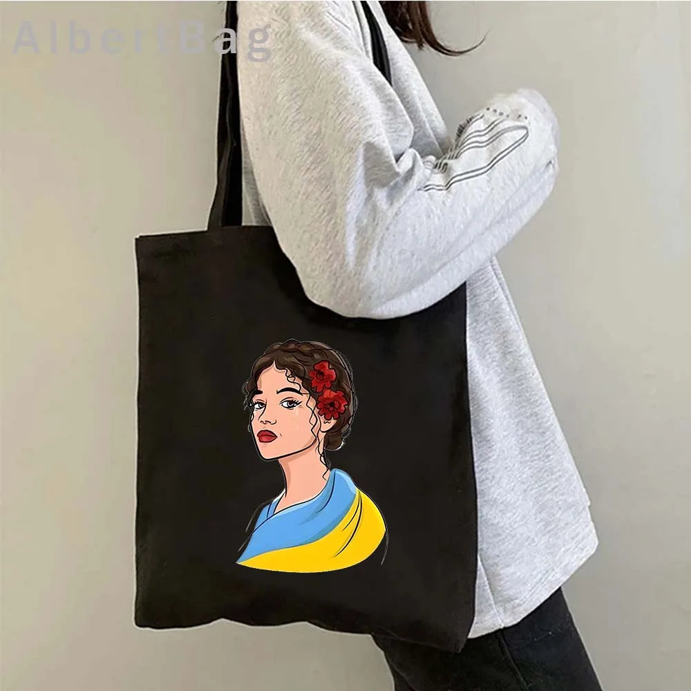 Ukrainian Patriotic Grocery Tote Bag with colorful design worn by person in gray sweater