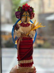 Unique Motanka Doll "Invincible" with dove and wheat on wooden stand, symbolizing strength and peace, handmade Ukrainian talisman.