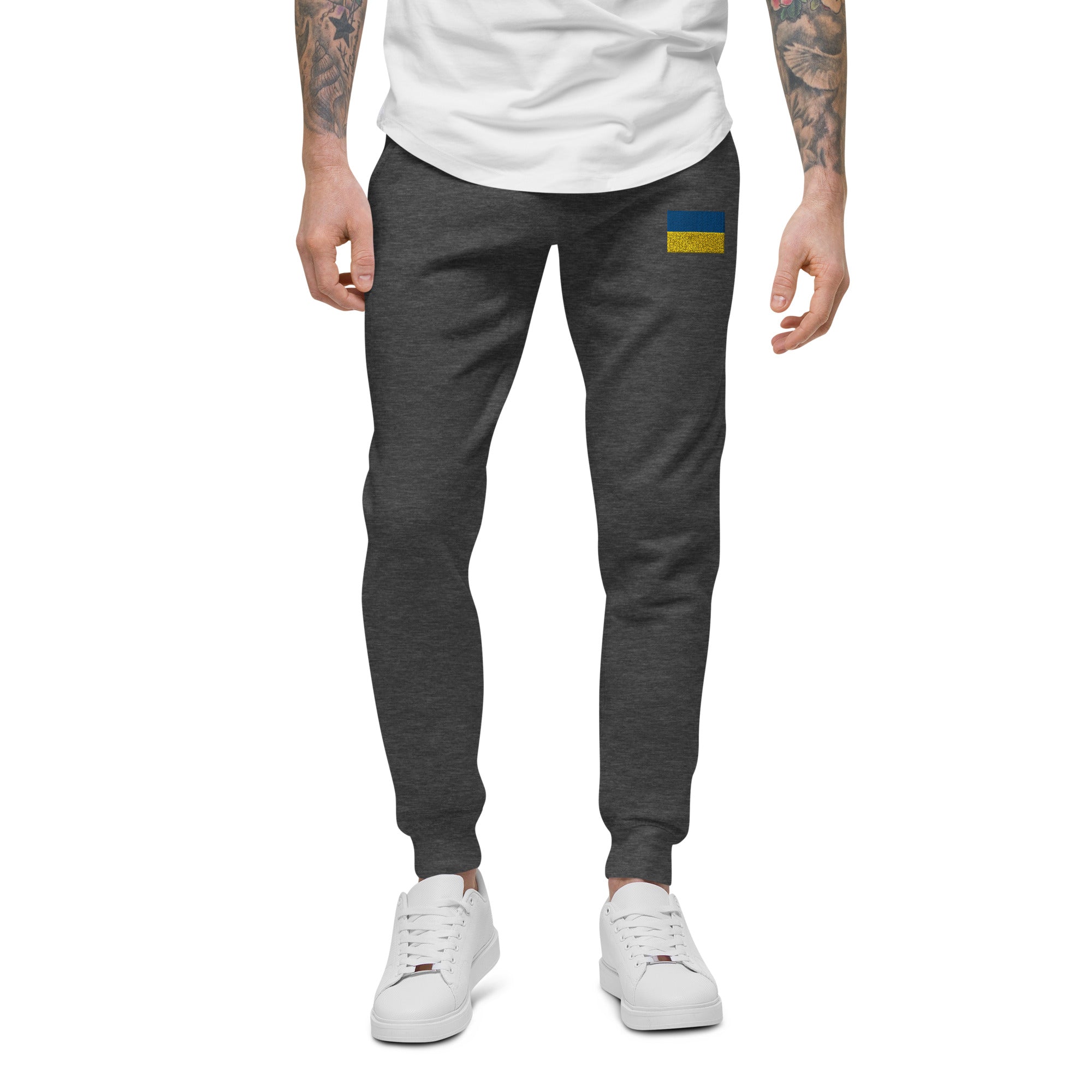 Ukrainian Flag fleece sweatpants in charcoal, featuring cozy lining and unisex design, styled with white sneakers and a tee.