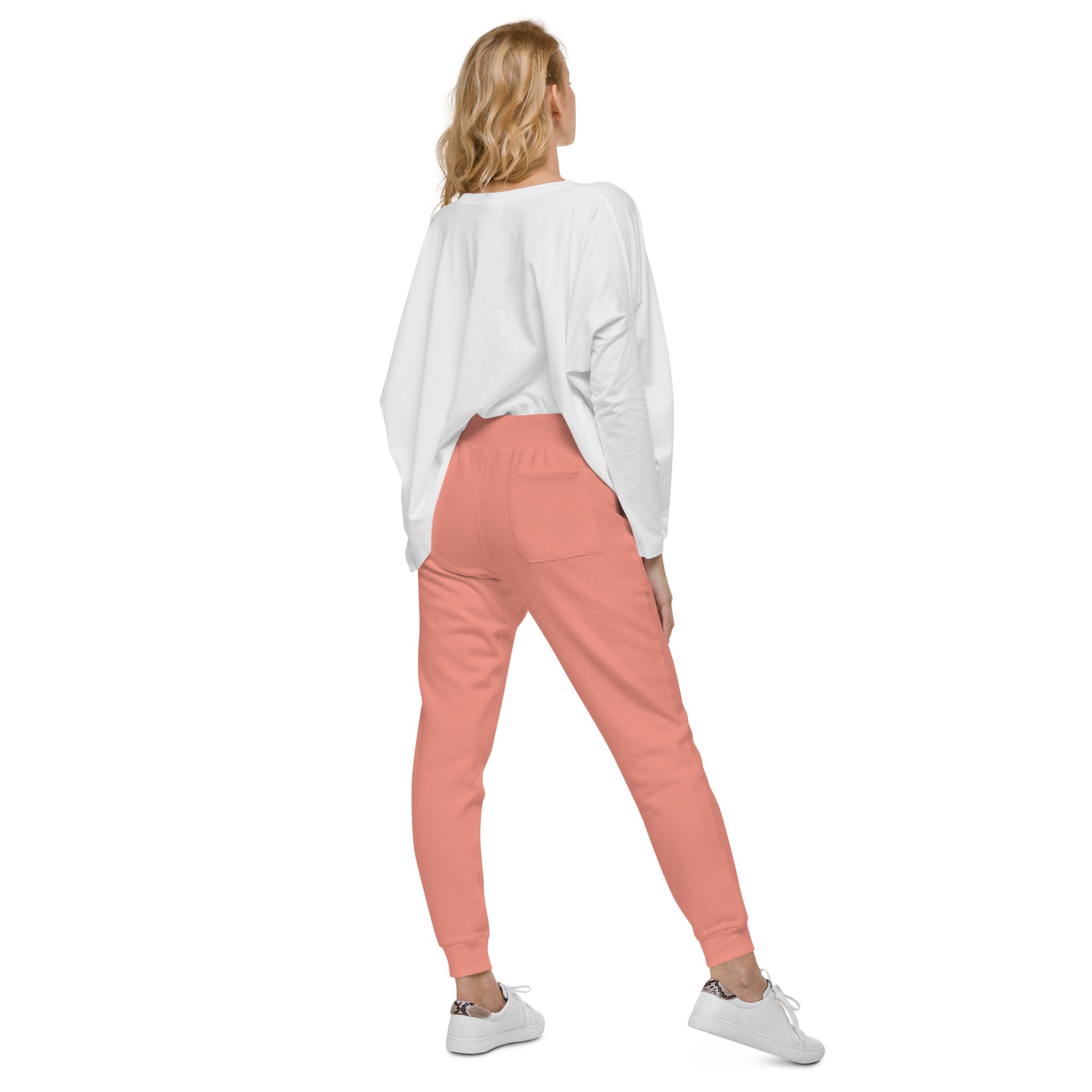Woman wearing Ukrainian Flag fleece sweatpants from the Ukrainian Vibe Trizub Collection, paired with a white shirt and sneakers.