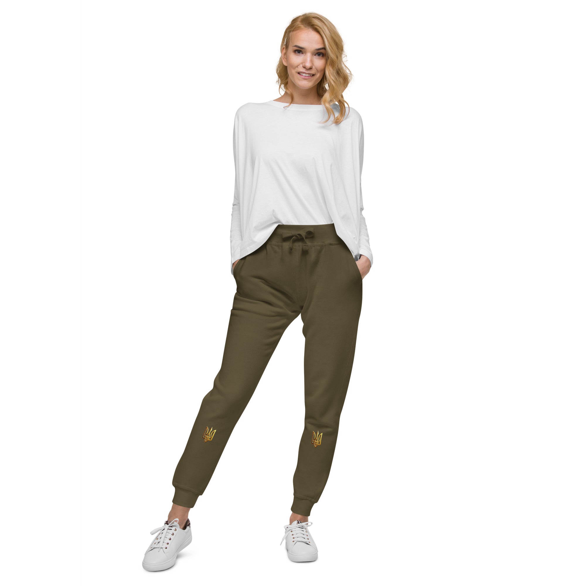 Model wearing unisex fleece sweatpants from the Ukrainian Vibe Trizub Collection paired with a white top and sneakers.