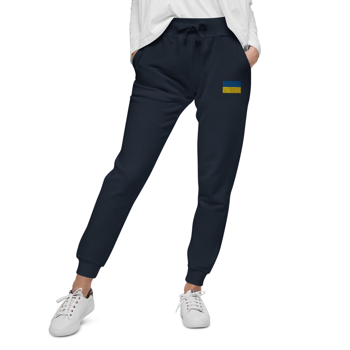 Ukrainian Flag fleece sweatpants with embroidered flag detail, soft lining, paired with white sneakers for casual style.