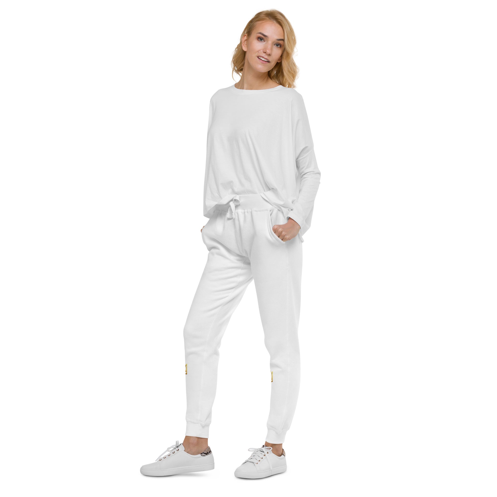 Model wearing white unisex fleece sweatpants from the Ukrainian Vibe Trizub Collection with a relaxed fit, styled with white sneakers.
