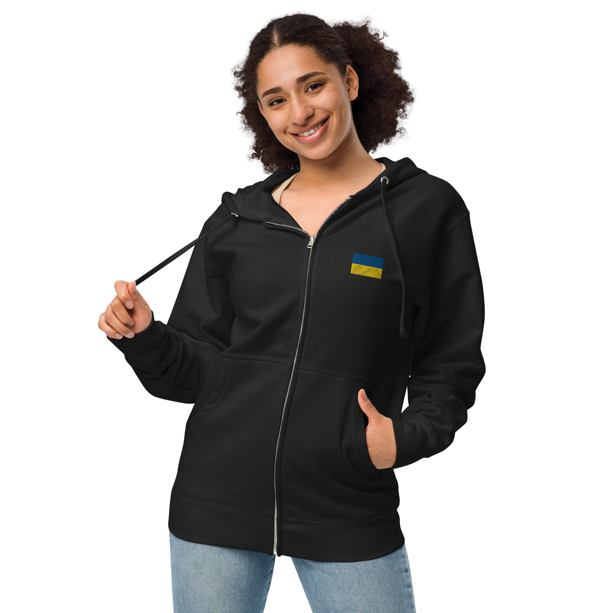 Woman wearing Ukrainian Flag fleece zip-up hoodie from Ukrainian Vibe Trizub Collection, featuring cozy jersey-lined hood.