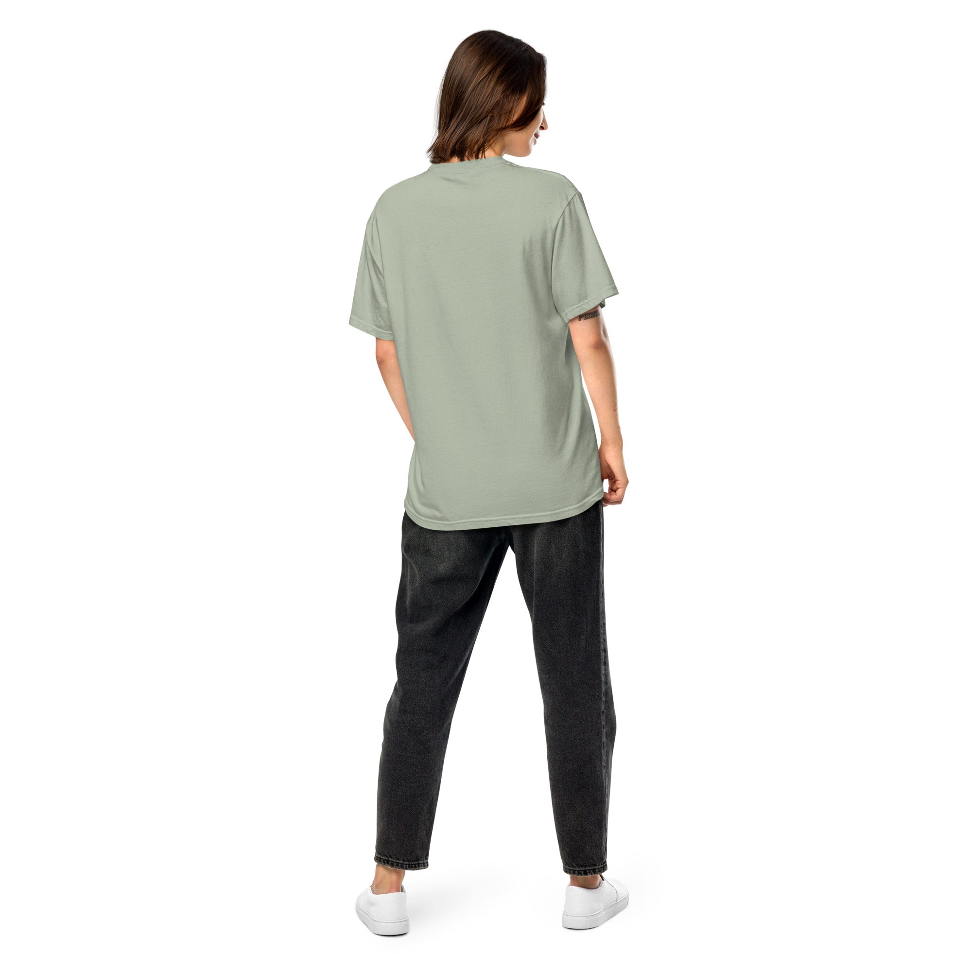 Back view of woman wearing Ukrainian Vibe Trizub Collection garment-dyed heavyweight t-shirt in sage green, relaxed fit.