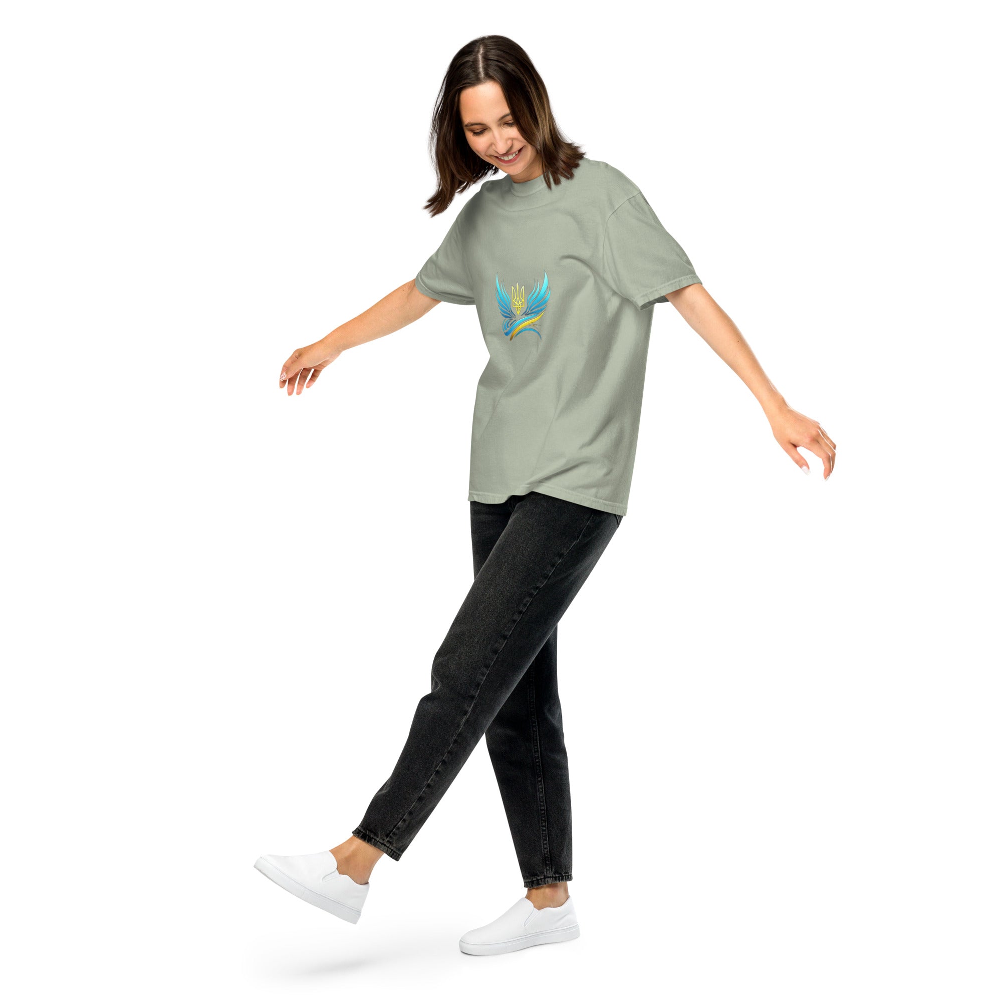 Woman wearing Ukrainian Vibe Trizub garment-dyed heavyweight t-shirt in sage, showcasing relaxed fit and casual style.