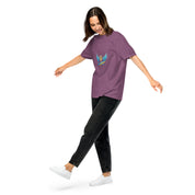 Woman wearing Ukrainian Vibe Trizub Collection garment-dyed heavyweight t-shirt and black jeans, showcasing casual style.