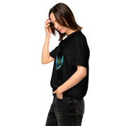 Woman wearing Ukrainian Vibe Trizub Collection heavy T-shirt, black with embroidered design, casual styling, side pose.