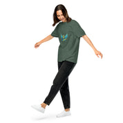 Woman wearing Ukrainian Vibe Trizub Collection T-shirt, green garment-dyed heavyweight, relaxed fit, casual style.