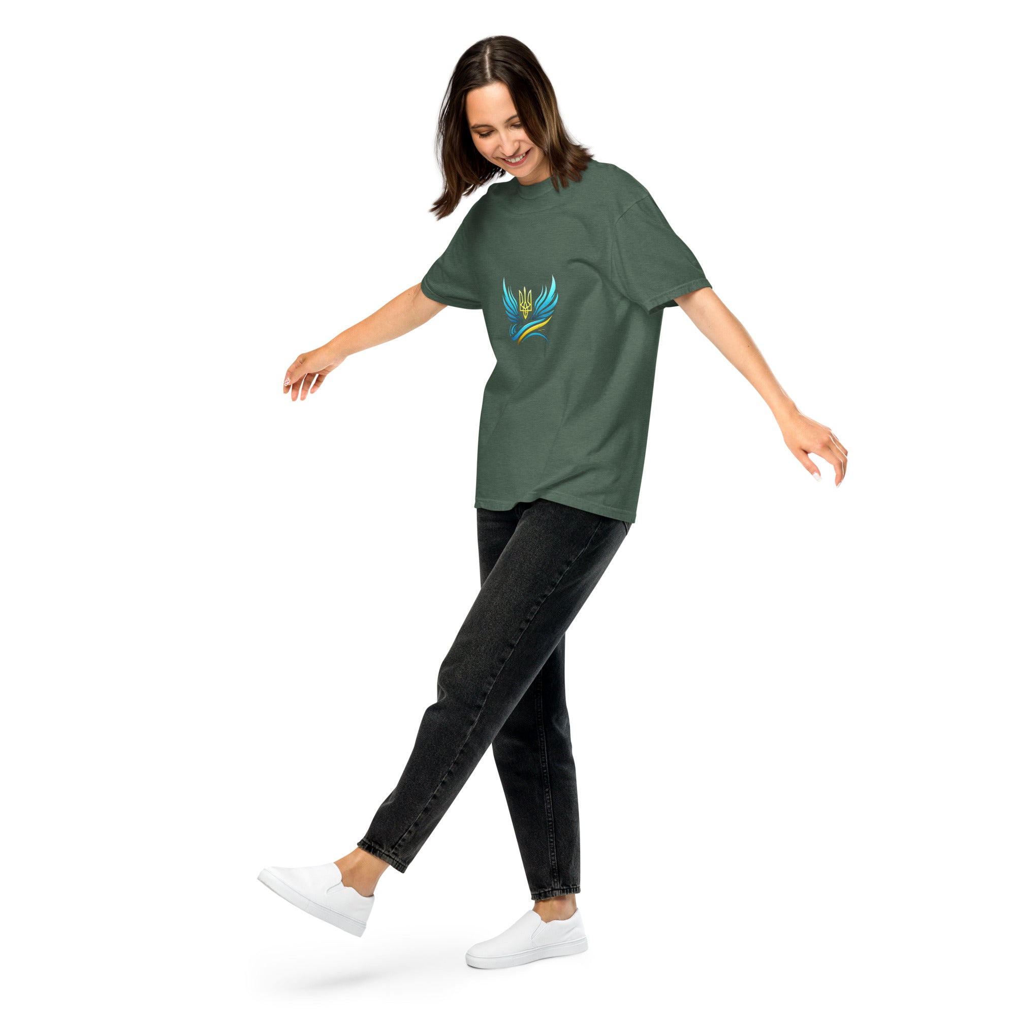 Woman wearing Ukrainian Vibe Trizub Collection T-shirt, green garment-dyed heavyweight, relaxed fit, casual style.