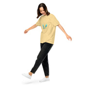 Model wearing Ukrainian Vibe Trizub Collection women's heavyweight t-shirt in yellow, featuring unique Trizub design on front, casual style.