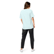 Back view of woman wearing Ukrainian Vibe Trizub Collection garment-dyed heavyweight t-shirt in light blue with relaxed fit and black jeans.