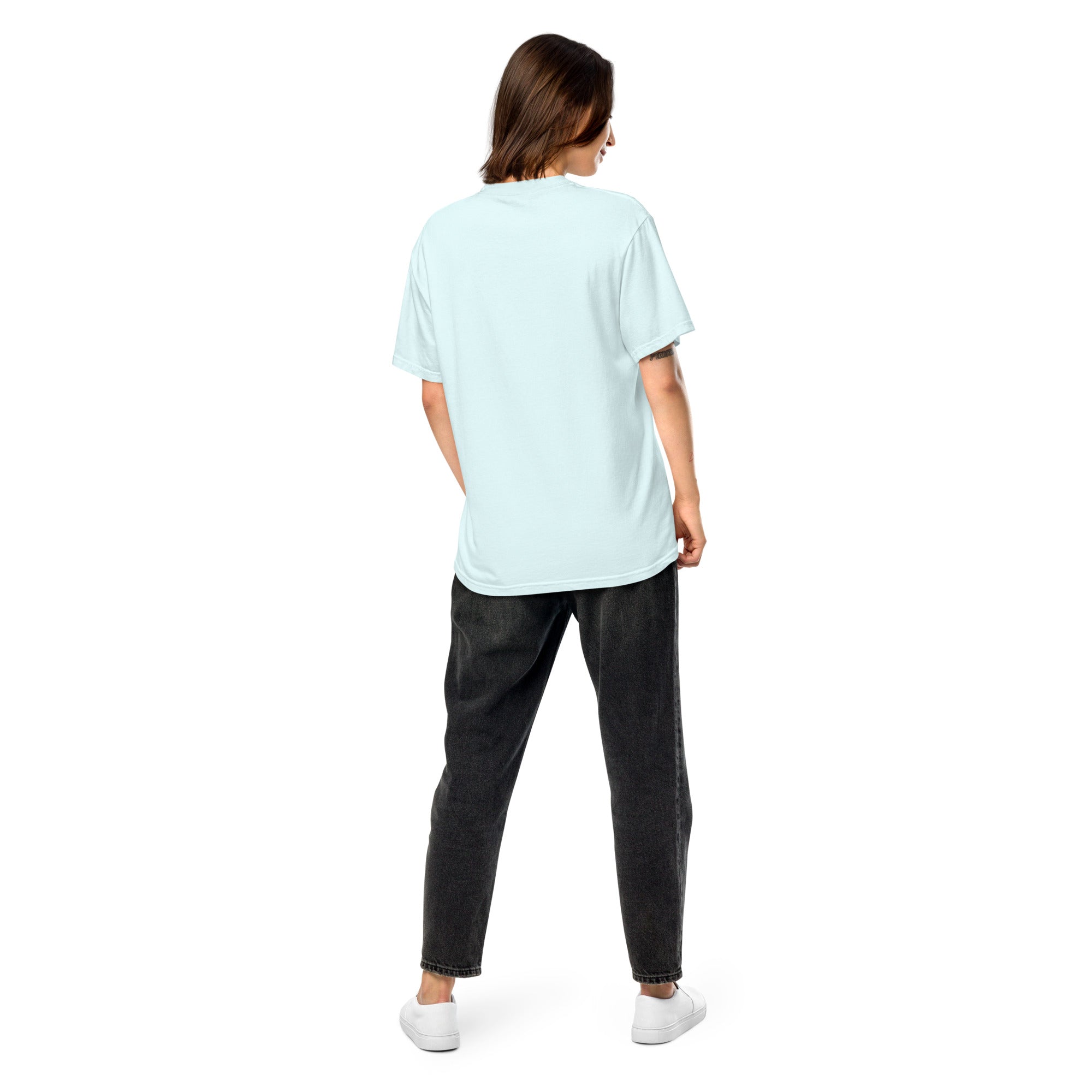 Back view of woman wearing Ukrainian Vibe Trizub Collection garment-dyed heavyweight t-shirt in light blue with relaxed fit and black jeans.