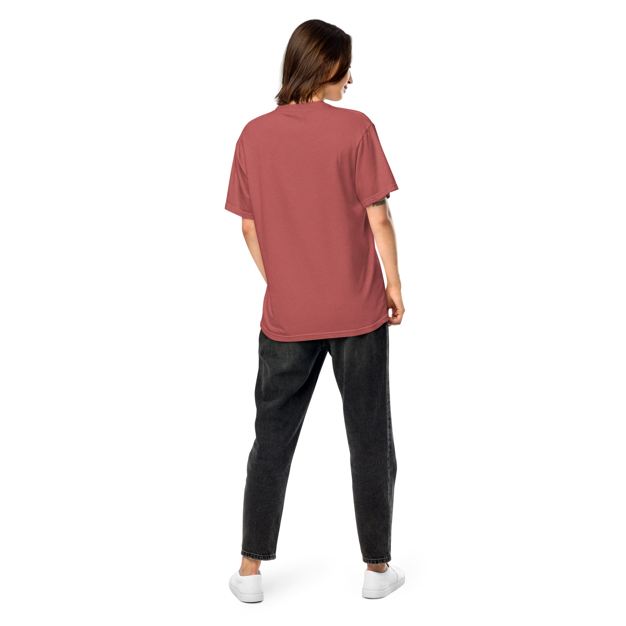 Back view of model wearing Ukrainian Vibe Trizub Collection women's garment-dyed red t-shirt and black jeans for a casual look.