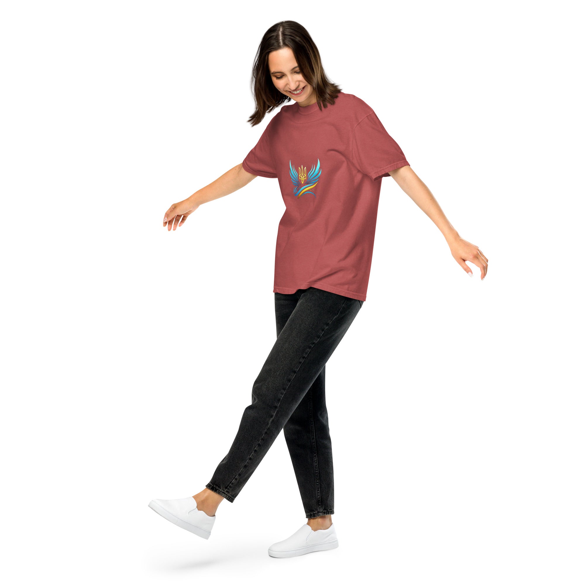 Woman wearing a relaxed fit, garment-dyed Ukrainian Vibe Trizub Collection t-shirt, 100% cotton, with embroidered design, paired with black jeans.
