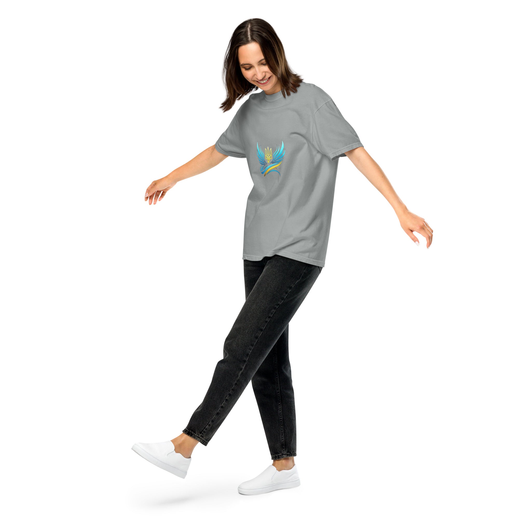 Woman wearing Ukrainian Vibe Trizub Collection heavyweight t-shirt, grey with embroidered design, styled with black jeans and white sneakers.