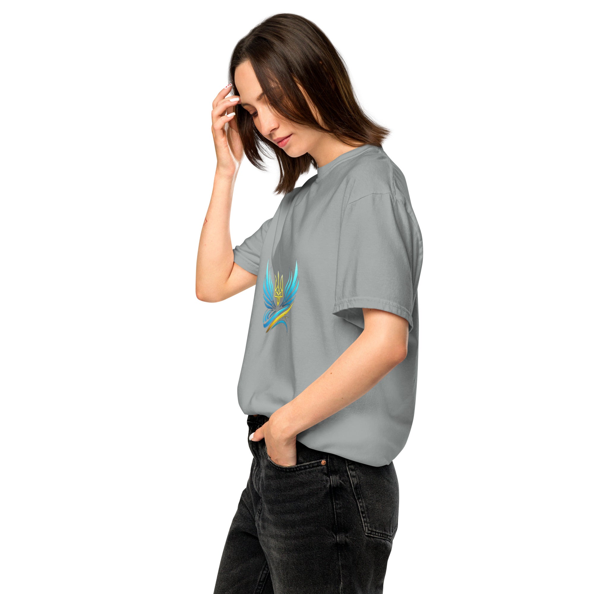 Woman wearing Ukrainian Vibe Trizub heavyweight t-shirt in gray, displaying a casual style with hands in pockets.