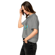 Woman wearing Ukrainian Vibe Trizub Collection garment-dyed heavyweight t-shirt in gray with trident design, casual style.