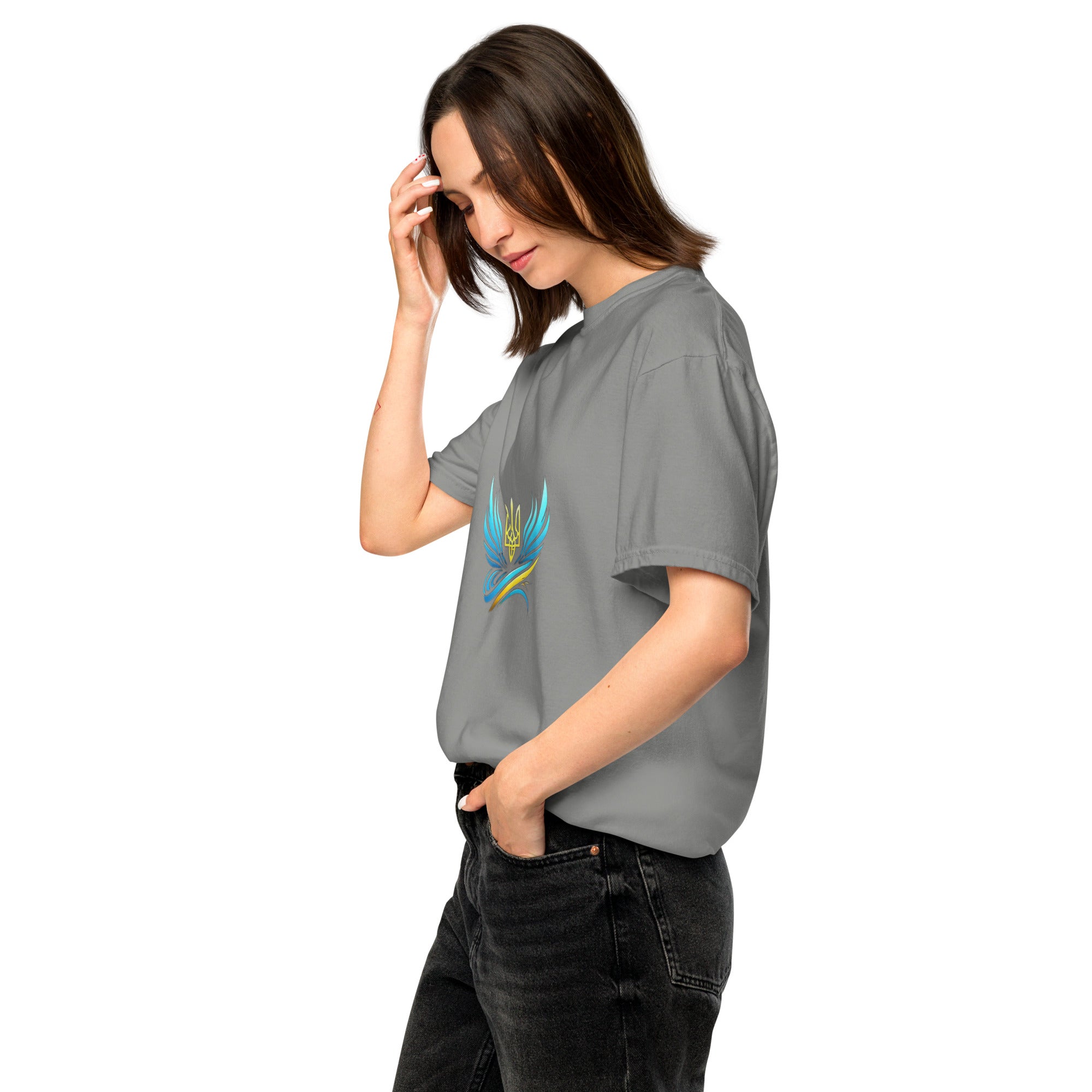 Woman wearing Ukrainian Vibe Trizub Collection garment-dyed heavyweight t-shirt in gray with trident design, casual style.