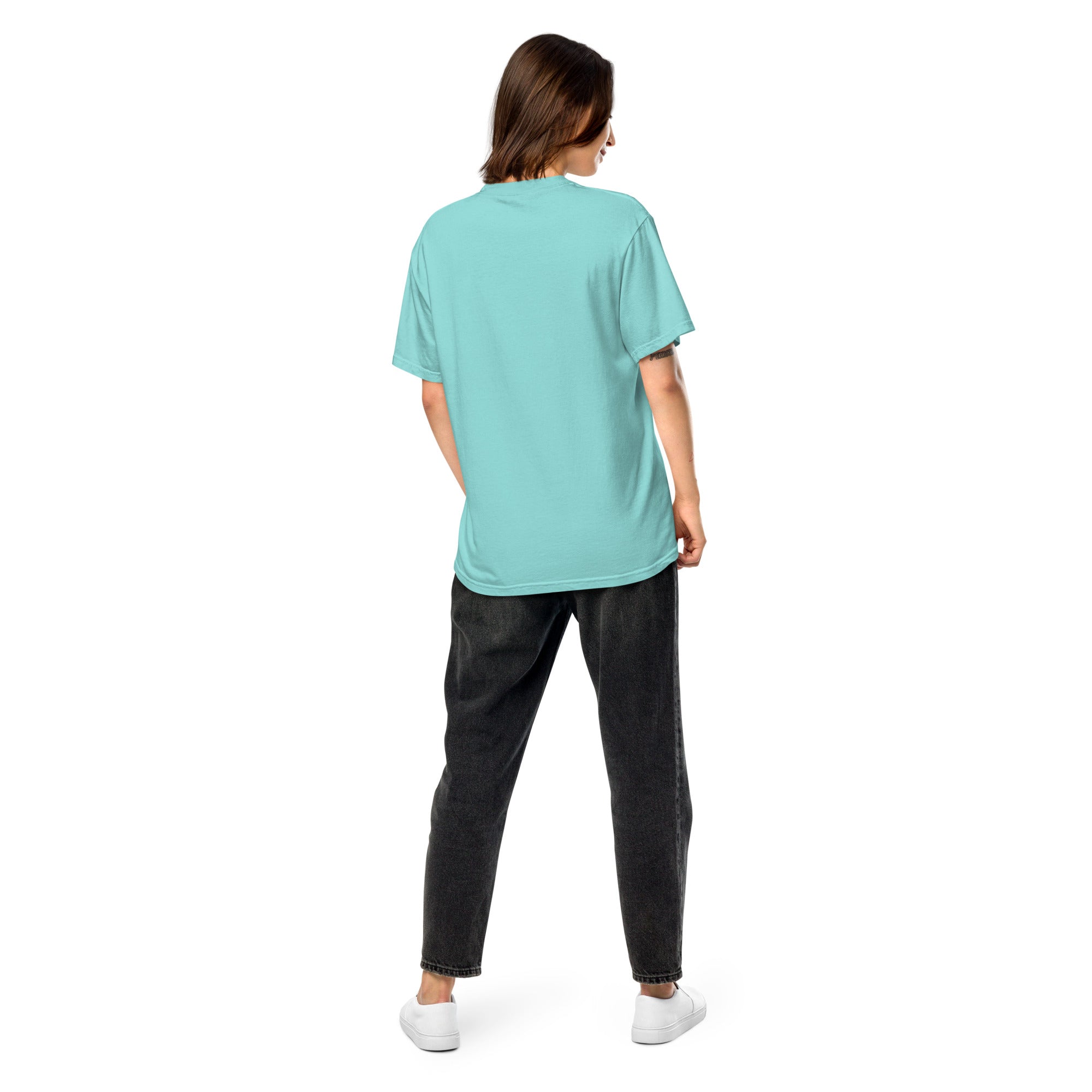 Back view of a woman wearing a blue Ukrainian Vibe Trizub Collection heavyweight t-shirt, paired with black jeans and white sneakers.