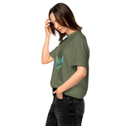 Woman wearing Ukrainian Vibe Trizub Collection garment-dyed t-shirt in olive. Features soft cotton, relaxed fit, and embroidered design.