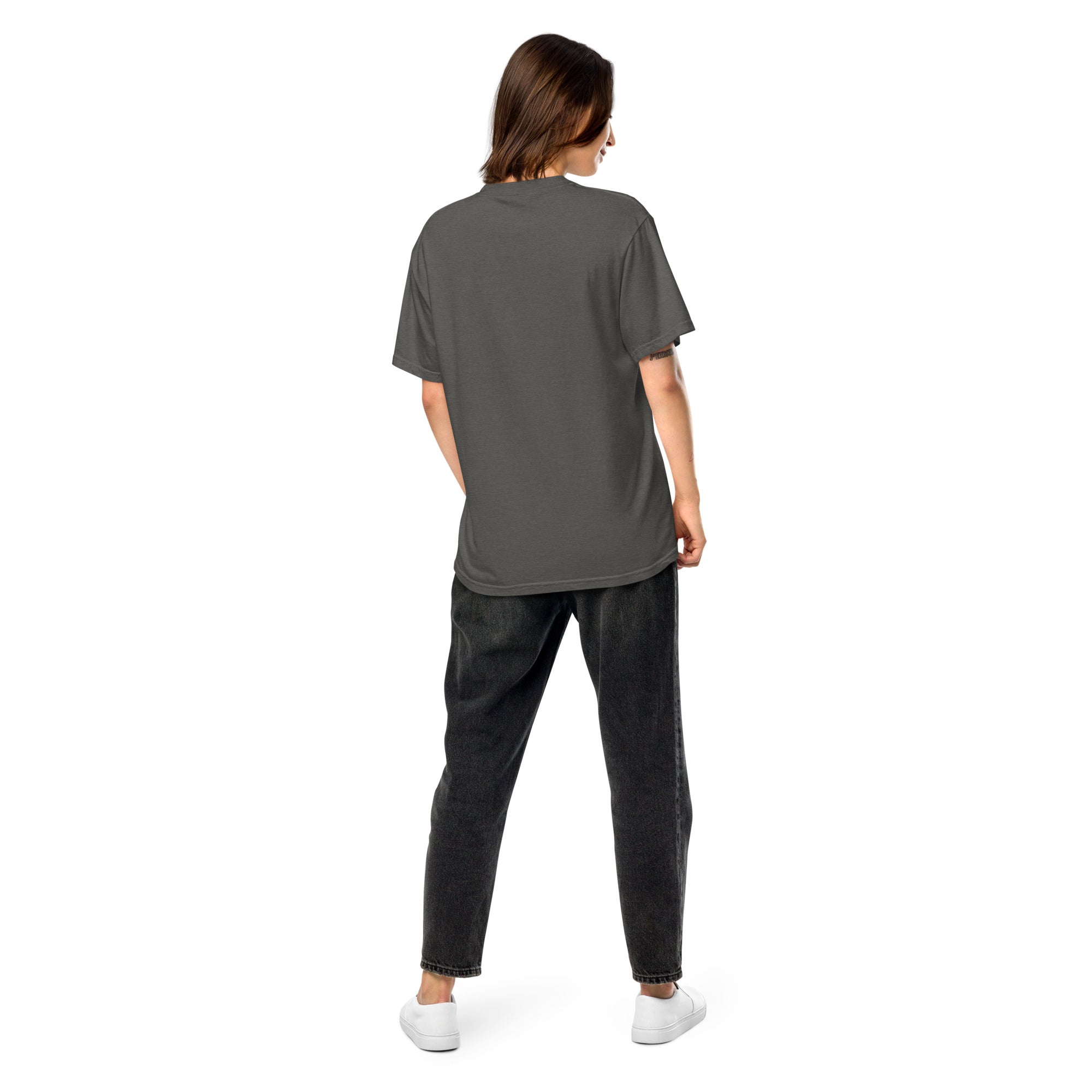 Back view of Ukrainian Vibe Trizub Collection women's garment-dyed heavyweight t-shirt in gray, worn by a model with casual jeans.