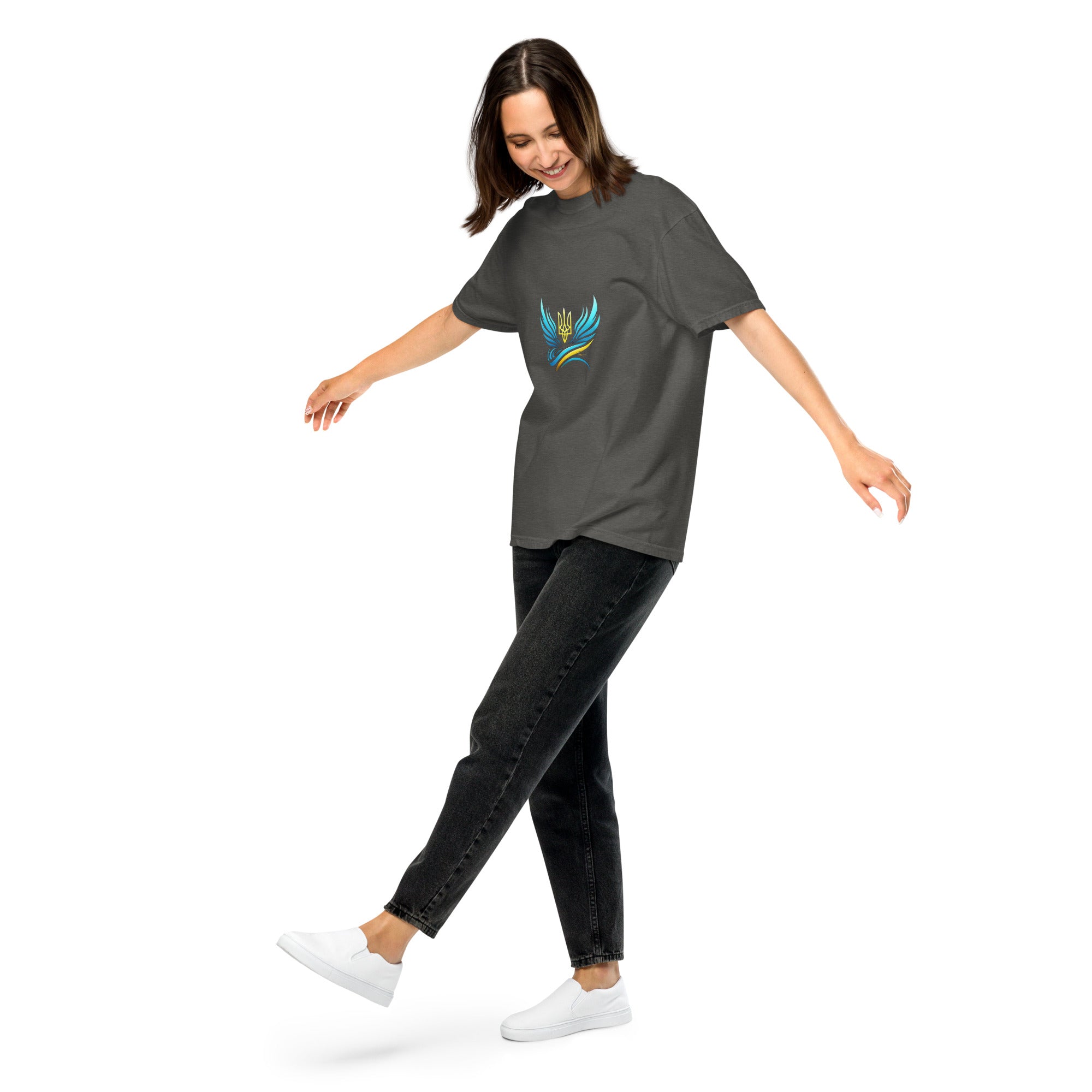 Woman wearing Ukrainian Vibe Trizub Collection heavyweight tee, charcoal with emblem, relaxed fit for casual style.