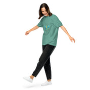 Woman wearing Ukrainian Vibe Trizub Collection heavyweight t-shirt in green, showcasing a relaxed fit and unique garment-dyed design.