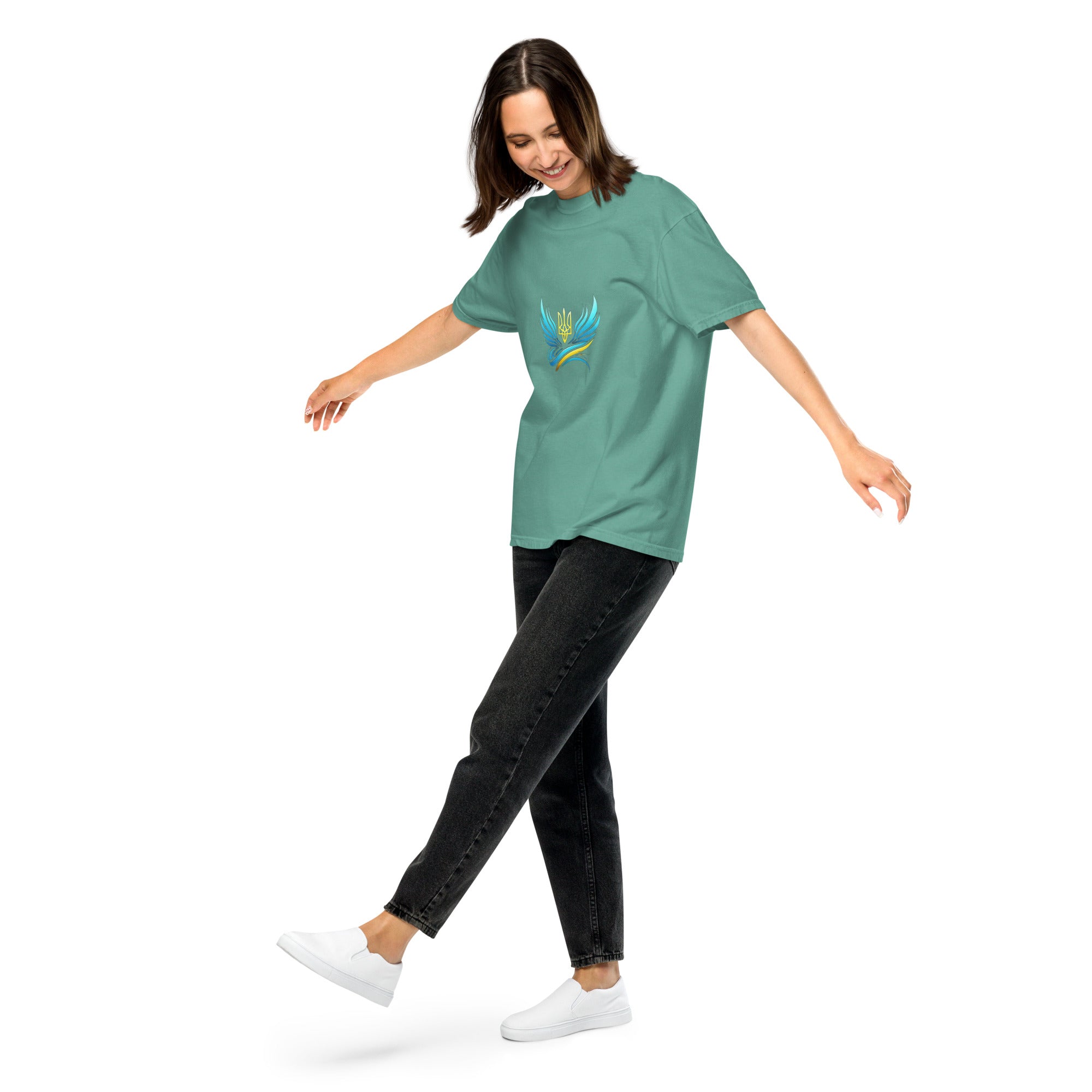 Woman wearing Ukrainian Vibe Trizub Collection heavyweight t-shirt in green, showcasing a relaxed fit and unique garment-dyed design.