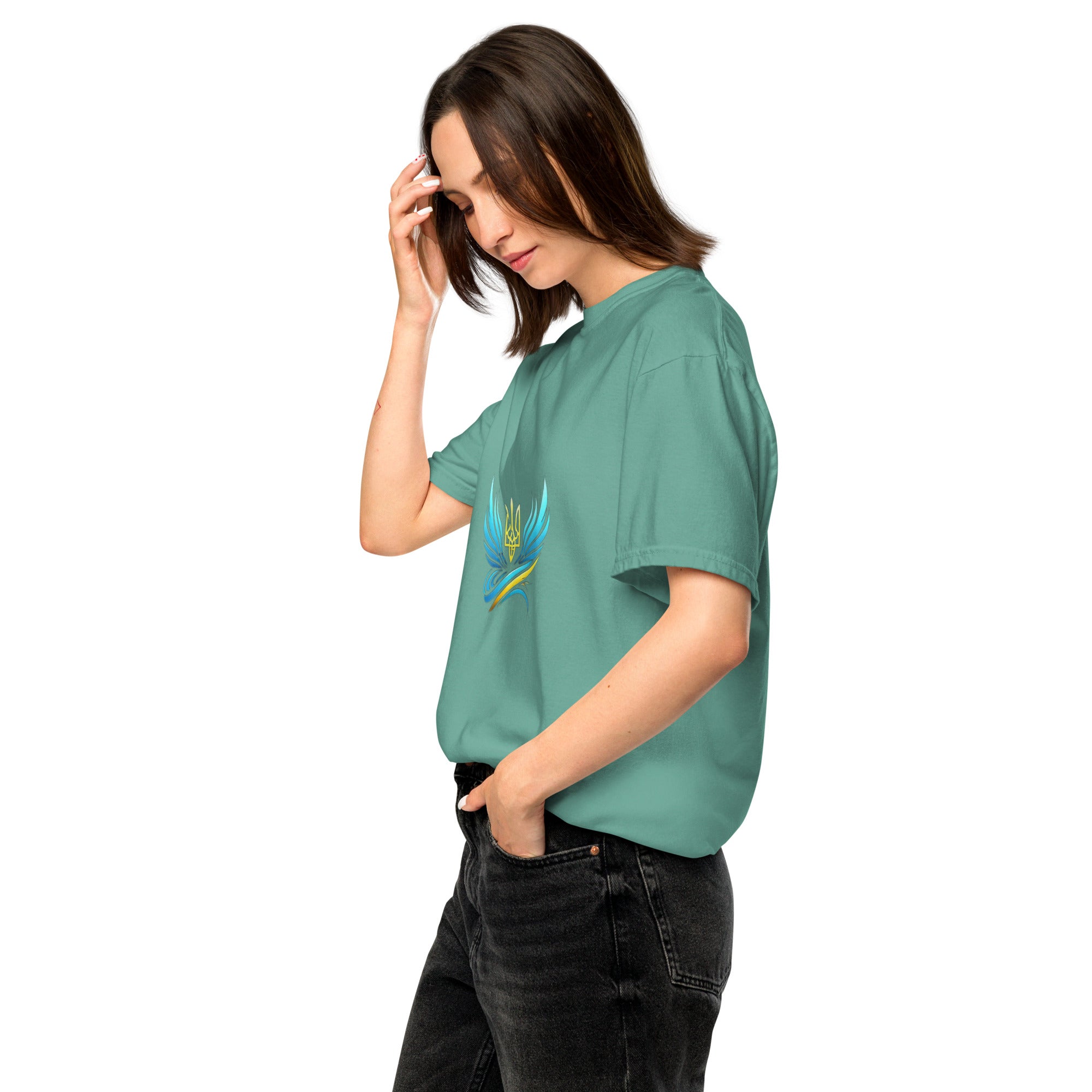 Woman wearing Ukrainian Vibe Trizub Collection heavyweight t-shirt in green, featuring garment-dyed finish and unique design.