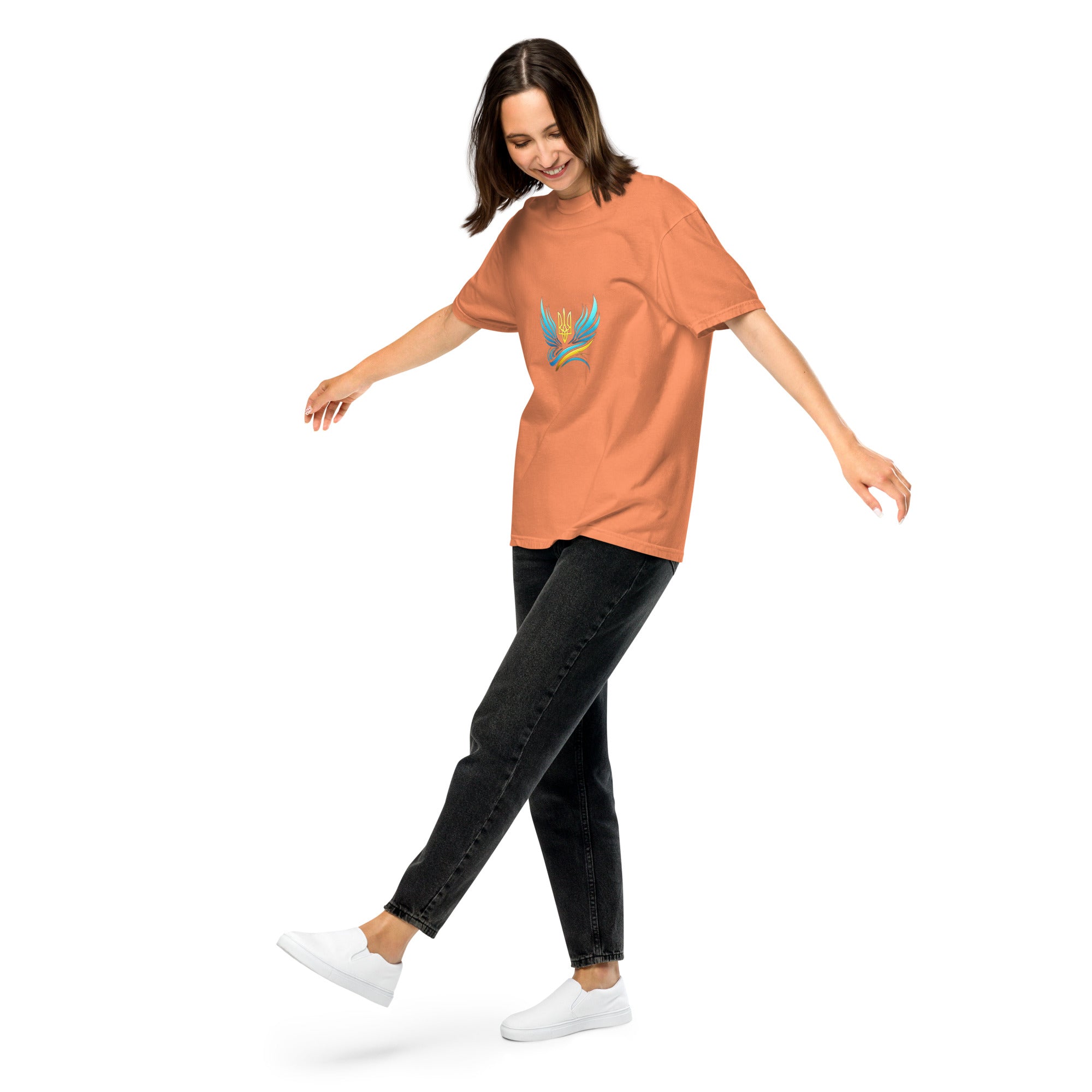 Woman wearing Ukrainian Vibe Trizub Collection orange heavyweight t-shirt, showcasing a casual look with relaxed fit and unique design.