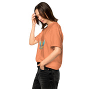 Woman wearing Ukrainian Vibe Trizub Collection garment-dyed heavyweight t-shirt in rust, featuring a relaxed fit and stylish Trizub design.