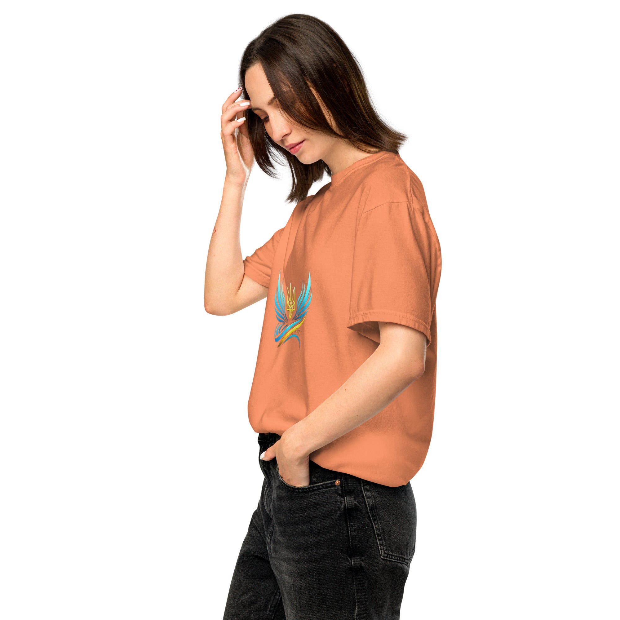Woman wearing Ukrainian Vibe Trizub Collection garment-dyed heavyweight t-shirt in rust, featuring a relaxed fit and stylish Trizub design.