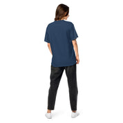 Model wearing Ukrainian Vibe Trizub Collection women's heavyweight blue t-shirt, back view showcasing loose fit and garment-dyed texture.