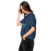 Woman wearing Ukrainian Vibe Trizub Collection navy blue heavyweight t-shirt, featuring an embroidered Trizub emblem, hand in hair.