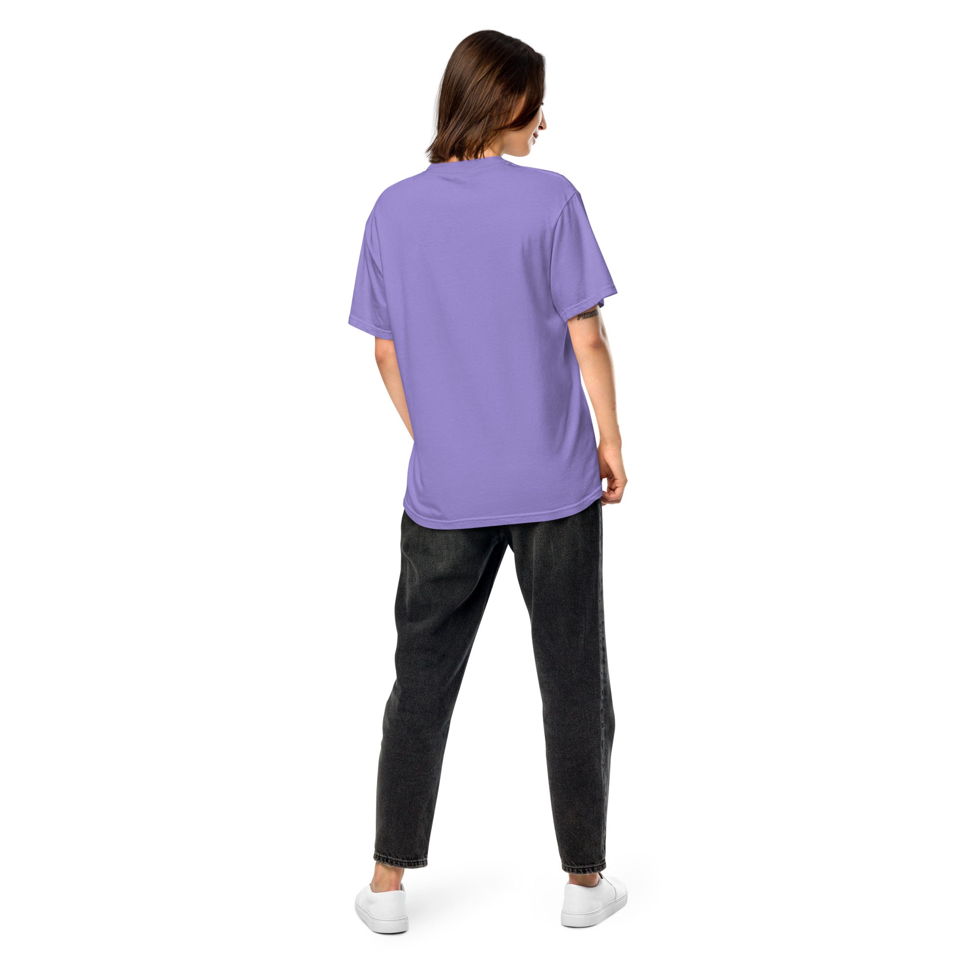 Back view of a woman wearing a purple Ukrainian Vibe Trizub Collection heavyweight t-shirt, showcasing its relaxed fit and garment-dyed finish.