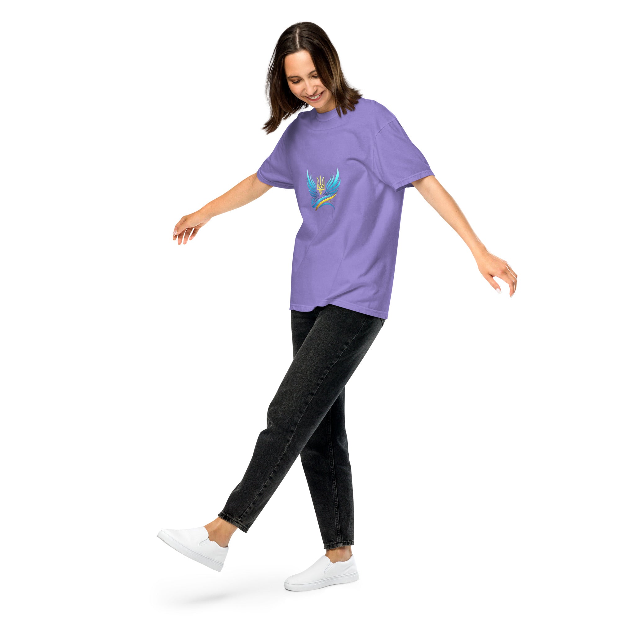 Woman wearing a purple Ukrainian Vibe Trizub Collection heavyweight t-shirt with a Trident emblem, paired with black jeans and white sneakers.