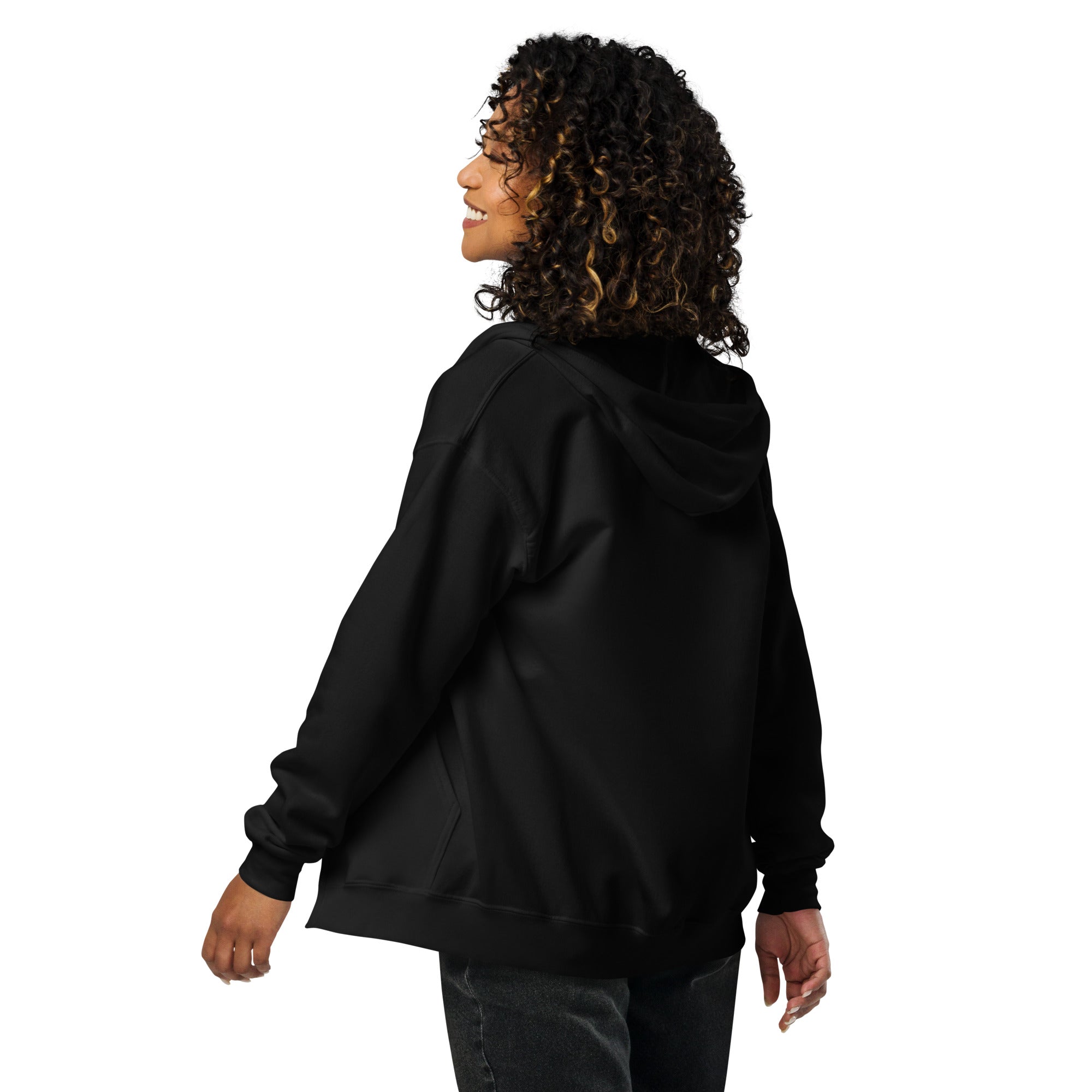 Woman wearing black zip hoodie from back, showcasing soft, cozy material in outdoor setting.