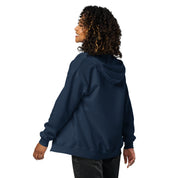 Woman wearing navy zip hoodie with Tryzub design from the back, showcasing soft fleece material and tailored fit.
