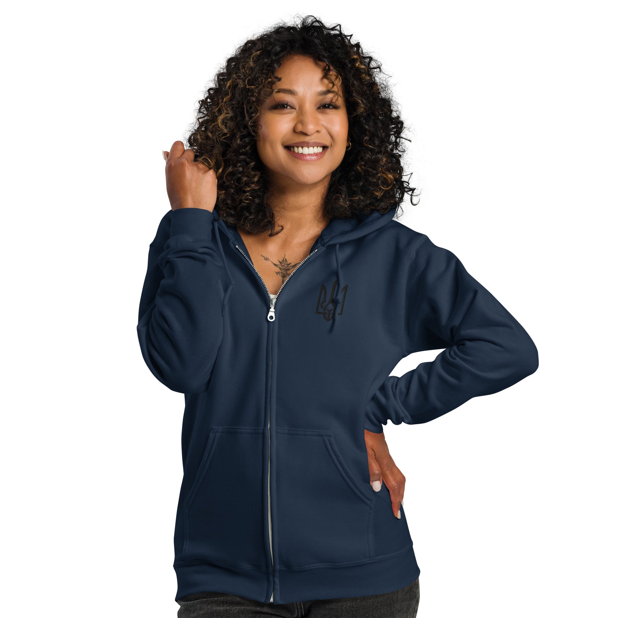 Woman wearing a cozy women's heavy blend zip hoodie with Ukrainian Tryzub, in dark blue, showcasing warmth and Ukrainian pride.
