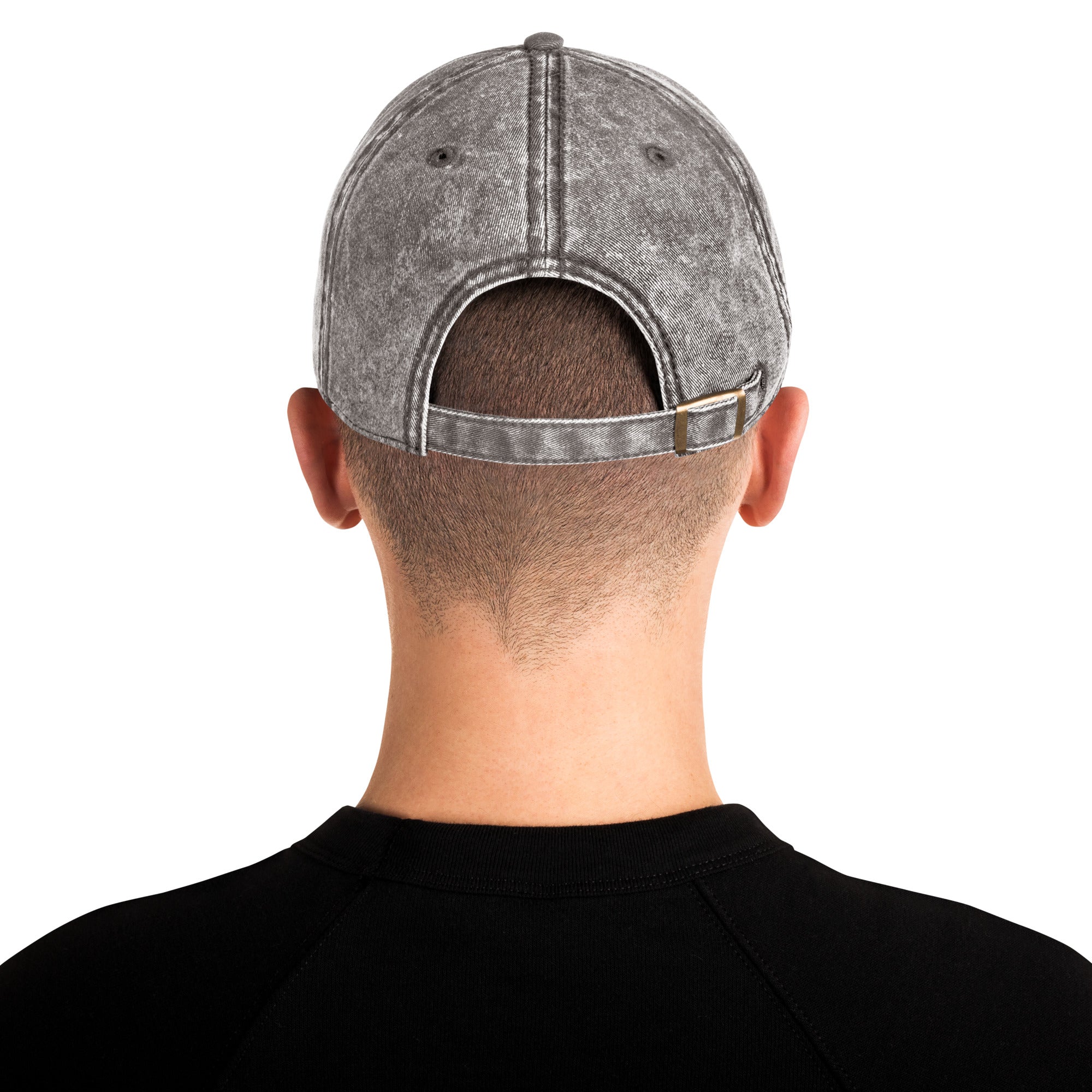 Back view of a vintage unisex cotton twill cap with an adjustable brass buckle, showcasing a trendy washed-out effect.