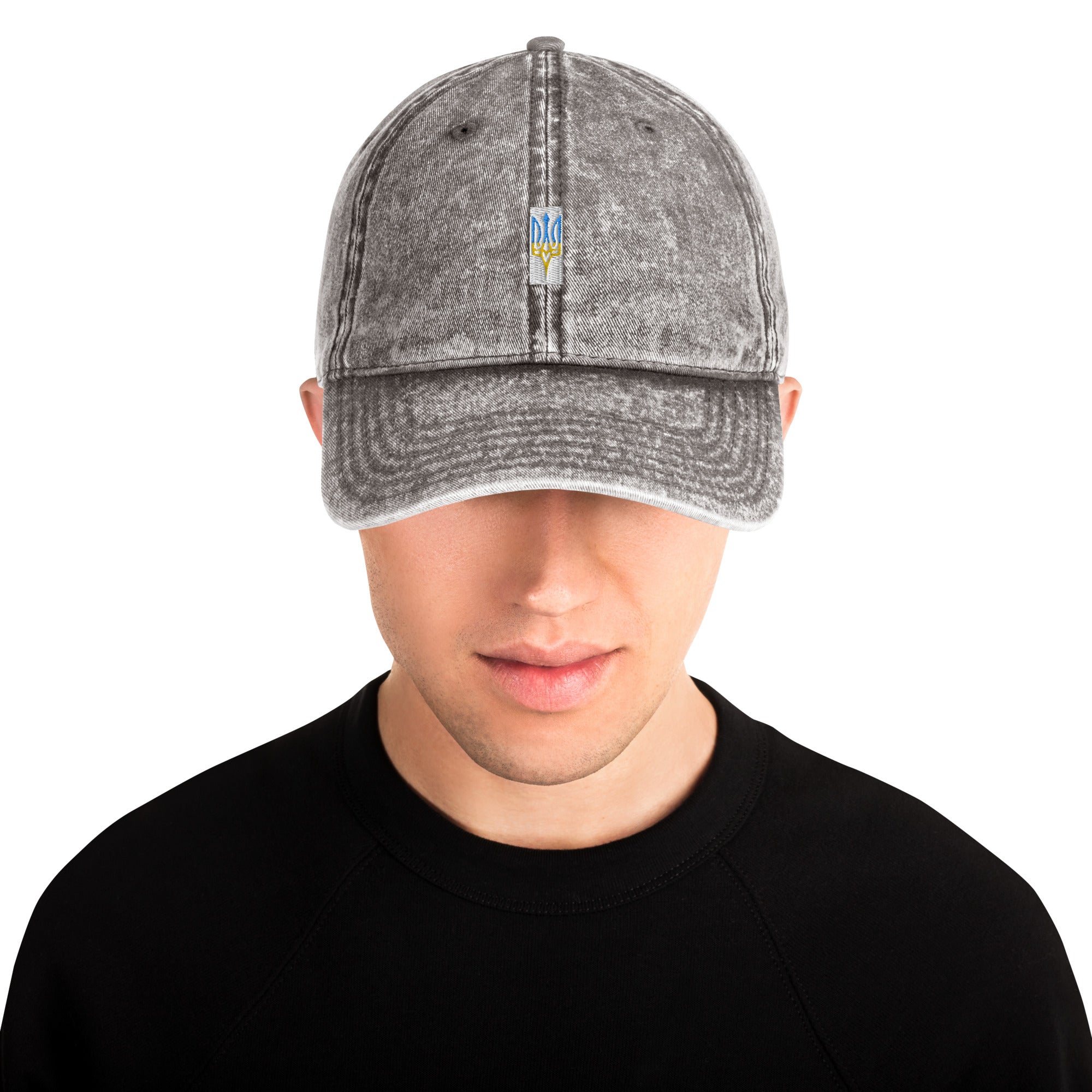 Vintage unisex cotton twill cap with embroidered Ukrainian Tryzub design, featuring a washed-out effect and adjustable brass buckle.