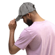 Man wearing vintage cotton twill cap with embroidered Ukrainian Tryzub, showcasing adjustable brass buckle and washed-out effect.