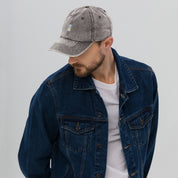 Man wearing vintage cotton twill cap with embroidered Ukrainian Tryzub, denim jacket, and white t-shirt, showcasing relaxed style.